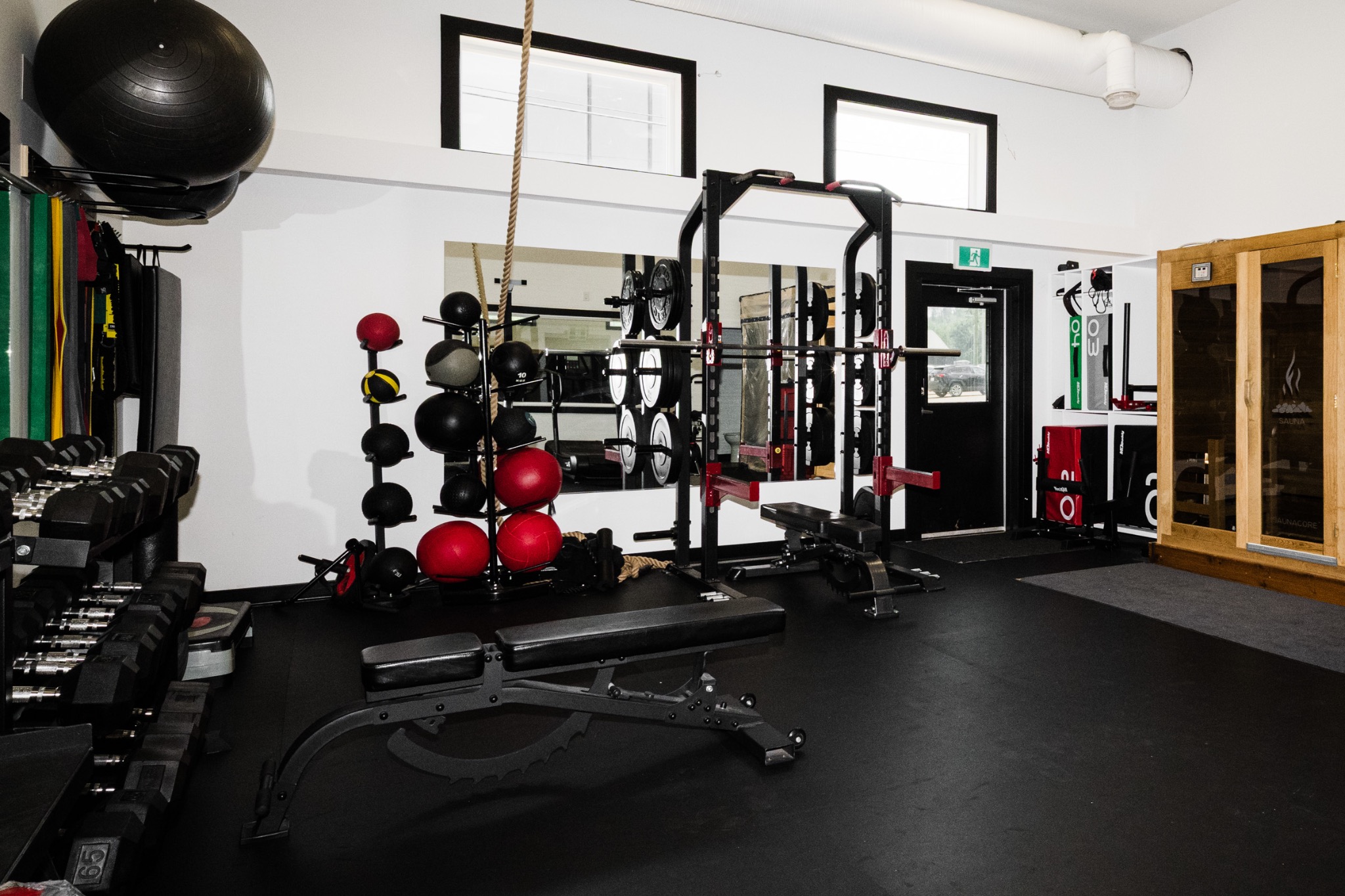 Free weights, benches and a squat rack in The Fort fitness room