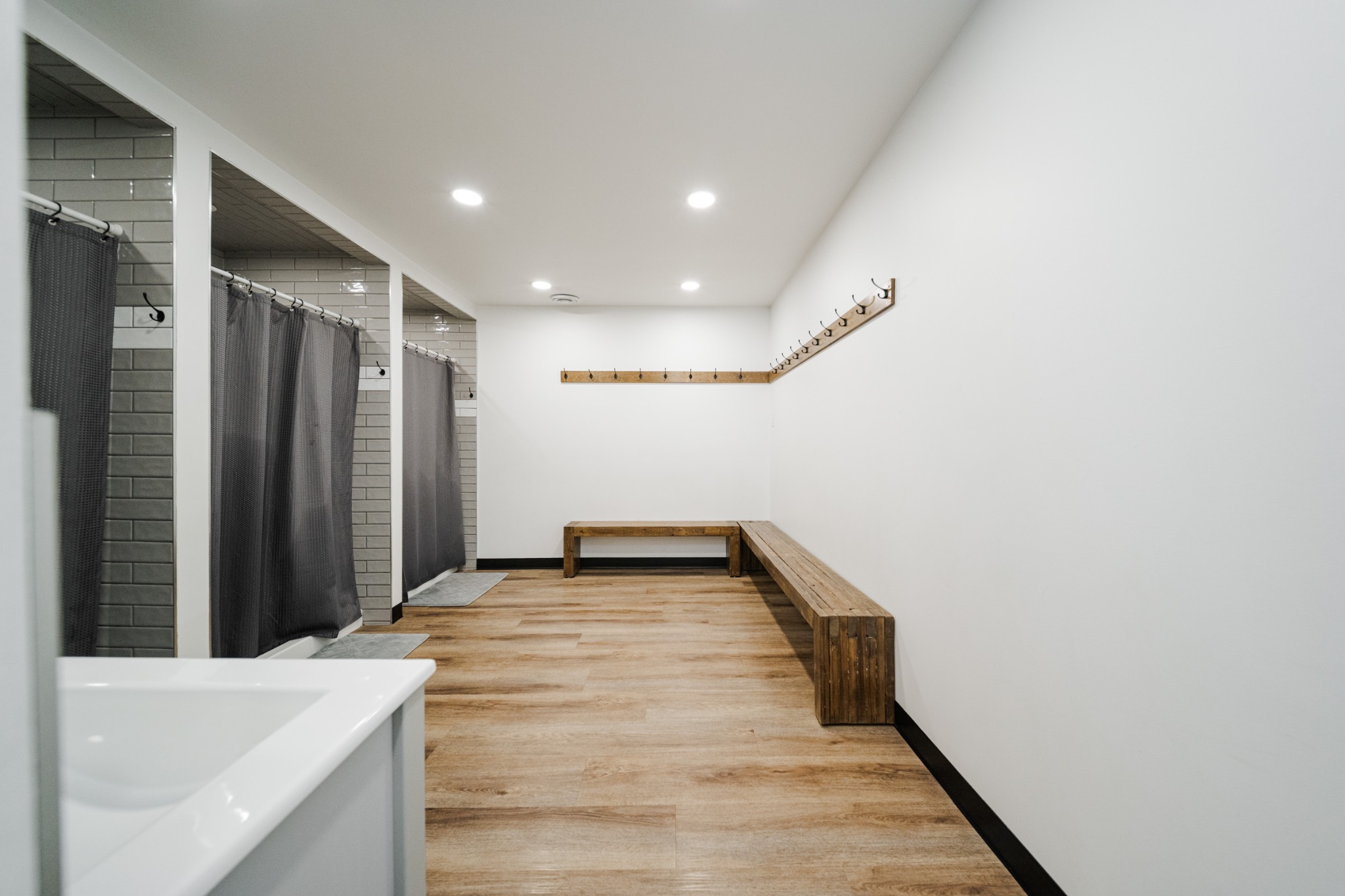 The Fort’s shower stalls and changing area with wooden benches