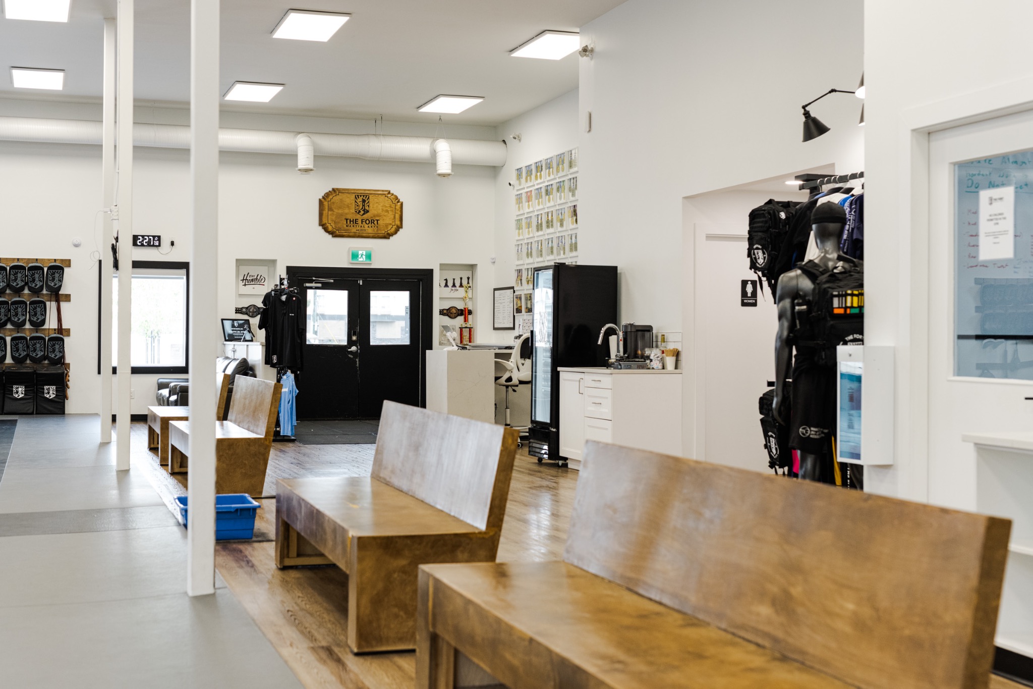 The Fort’s reception, coffee station and wooden seating beside the training floor