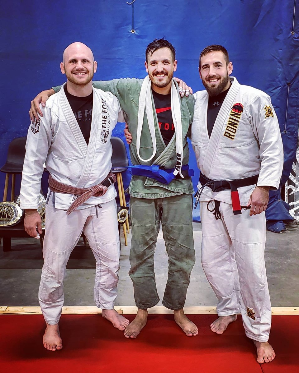 Chris wearing his new blue belt with Fort coaches