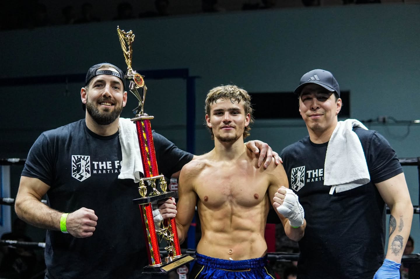 Matt Noble with his Fort coaches and trophy after his Muay Thai win